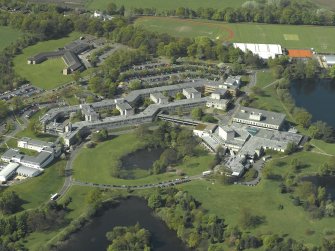 Oblique aerial view centred on Stirling University, library and auditorium, taken from the ENE.