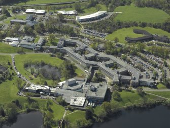Oblique aerial view centred on the university, library and auditorium, taken from the N.