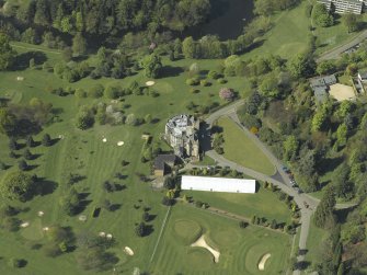 Oblique aerial view centred on the country house, taken from the E.