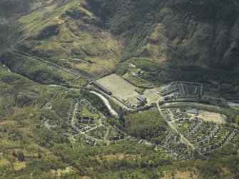 Oblique aerial view centred on the site of the works with the road bridge and church adjacent, taken from the NNW.