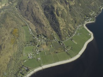 General oblique aerial view centred on the village with the remains of the dun adjacent, taken from the W.
