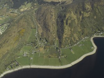 General oblique aerial view centred on the village with the remains of the dun adjacent, taken from the SW.