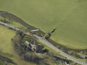 Oblique aerial view centred on Stow Kirk and Old Stow Bridge, taken from the NE.