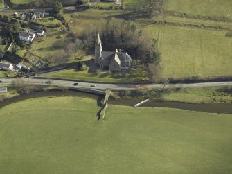Oblique aerial view centred on Stow Kirk and Old Stow Bridge, taken from the W.