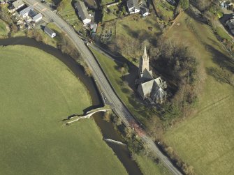 Oblique aerial view centred on Stow Church and old bridge, taken from the SSW.