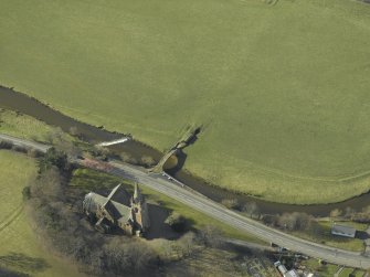 Oblique aerial view centred on Stow Kirk and Old Stow Bridge, taken from the NE.