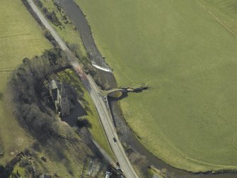 Oblique aerial view centred on Stow Kirk and Old Stow Bridge, taken from the N.