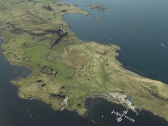 Oblique aerial view centred on the boatyard and the remains of the seaplane base with the house, farmhouse and farmsteading adjacent, taken from the E.