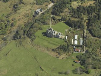 Oblique aerial view centred on the country house and walled garden, taken from the NW.