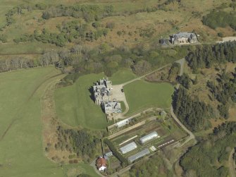 Oblique aerial view centred on the country house and walled garden, taken from the WSW.
