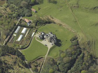 Oblique aerial view centred on the country house and walled garden, taken from the E.