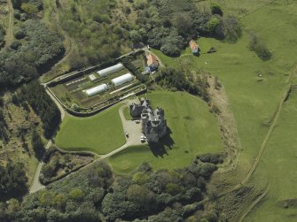Oblique aerial view centred on the country house and walled garden, taken from the NE.