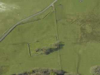 Oblique aerial view centred on the remains of the burial-ground, taken from the SE.