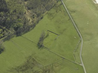 Oblique aerial view centred on the remains of the burial-ground, taken from the N.