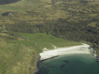 General oblique aerial view of Calgary Bay centred on the remains of the burial-ground with the country house and walled garden adjacent, taken from the W.