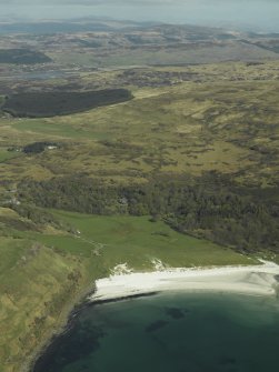 General oblique aerial view of Calgary Bay centred on the remains of the burial-ground with the country house and walled garden adjacent, taken from the W.