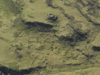 Oblique aerial view centred on the remains of the dun and crofting township, taken from the E.
