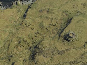 Oblique aerial view centred on the remains of the dun and crofting township, taken from the N.