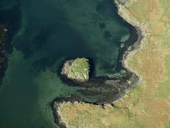 Oblique aerial view centred on the remains of the island dwelling, taken from the SSW.