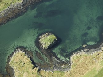 Oblique aerial view centred on the remains of the island dwelling, taken from the SE.