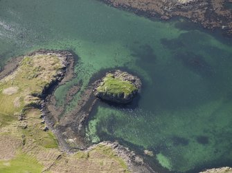 Oblique aerial view centred on the remains of the island dwelling, taken from the E.