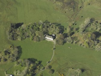 Oblique aerial view centred on the house, taken from the SSW.