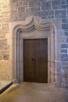 Interior. View of doorway in E side chapel leading to priest's house (door closed)