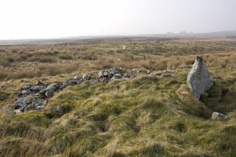The cairn and chamber from the SE, with Achkinloch stone setting (ND14SE 2) in the background.