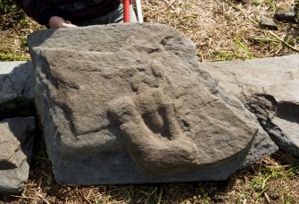 Fragment of west highland grave slab - tunic and sword