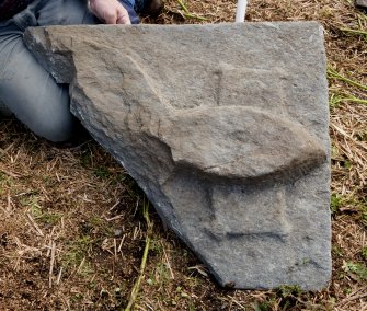 Fragment of west highland grave slab - head of effigy resting on pillow