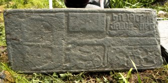 Fragment of west highland grave slab showing galley, sword hilt and decoration