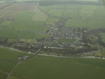 Oblique aerial view centred on village and the Teviot Bridge, taken from N.