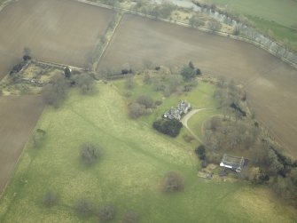 Oblique aerial view centred on the house, stables and walled garden, taken from the NNW.
