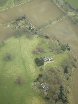 Oblique aerial view centred on the house, stables and walled garden, taken from the SW.