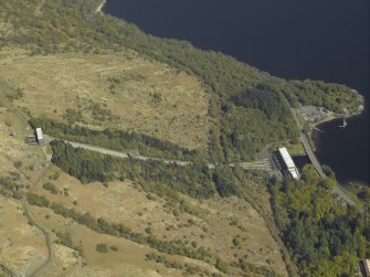 Oblique aerial view centred on the Loch Sloy hydro-electric power station, feeder pipes and valve house, taken from the SSW.