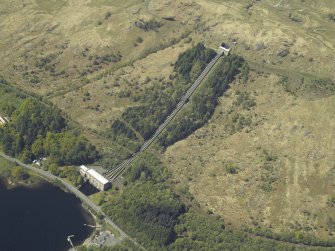 Oblique aerial view centred on the hydro-electric power station, feeder pipes and valve house, taken from the E.
