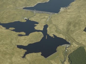 General oblique aerial view centred on the dams, power station and reservoir, taken from the SSW.