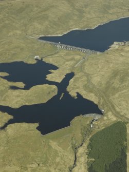 General oblique aerial view centred on the dams, power station and reservoir, taken from the SSW.