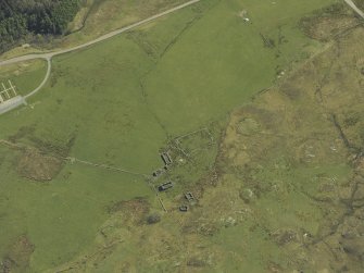 Oblique aerial view centred on the remains of the cairn and township, taken from the NW.