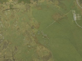 Oblique aerial view centred on the remains of the cairn and township, taken from the SW.