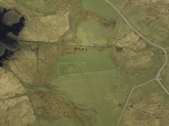 Oblique aerial view centred on the remains of the church and the burial ground, taken from the SW.