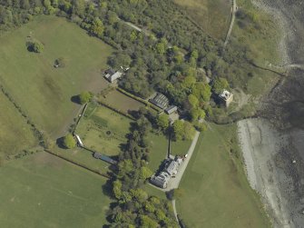 Oblique aerial view centred on the towerhouse, country house, walled garden and farmsteading, taken from the WNW.