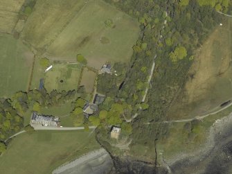 Oblique aerial view centred on the towerhouse, country house, walled garden and farmsteading, taken from the SW.