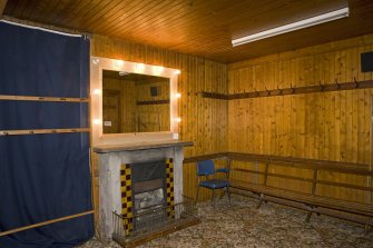 Interior. Under stage area, view of  timber lined dressing room with chimneypiece