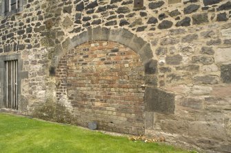 Detail of blocked arched entrance in warehouse wall