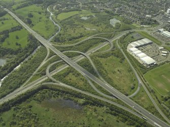 Oblique aerial view centred on the motorway interchange, taken from the S.