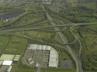 Oblique aerial view centred on the motorway interchange, taken from the WSW.