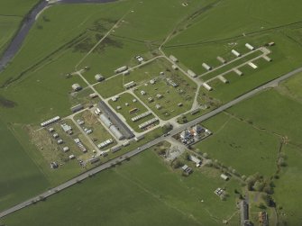 Oblique aerial view centred on the disused explosives factory, taken from the NE.