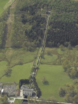 Oblique aerial view centred on the feeder pipes with the power station in the foreground, taken from the NE.