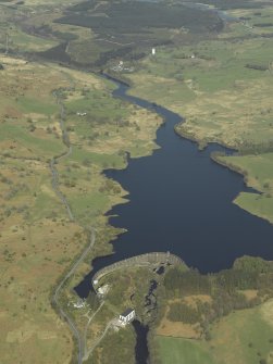 General oblique aerial view centred on the loch with the dam and power station in the foreground, taken from the SSE.